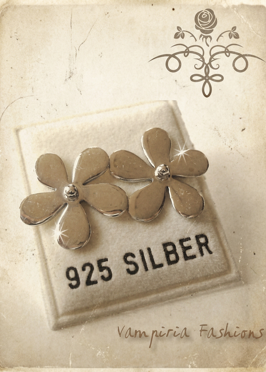 Zwei silberfarbene Blumen-Ohrstecker auf Schmuckkarte mit Aufdruck „925 Silber“, helle Vintage-Darstellung mit dekorativem Hintergrund.
